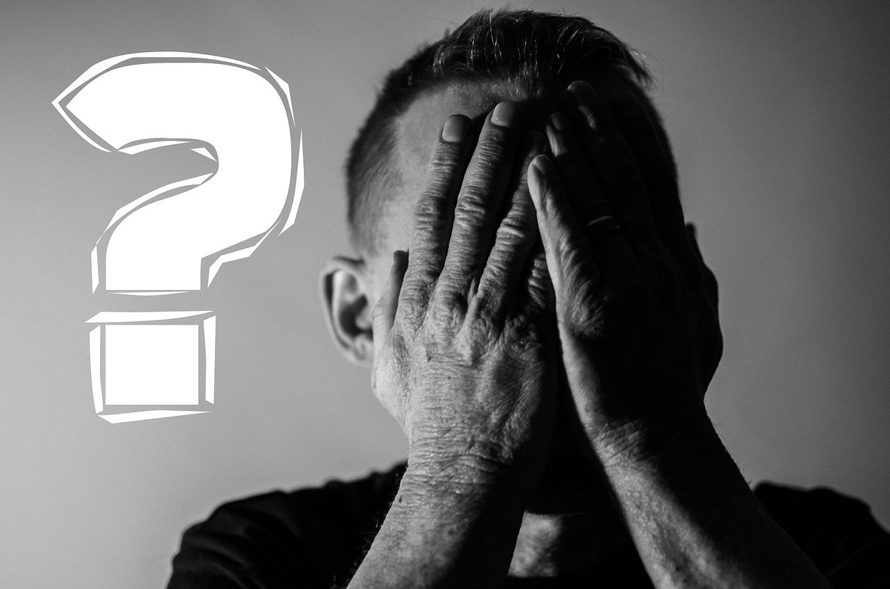 Man holds hands in front of his face next to illustration of question mark